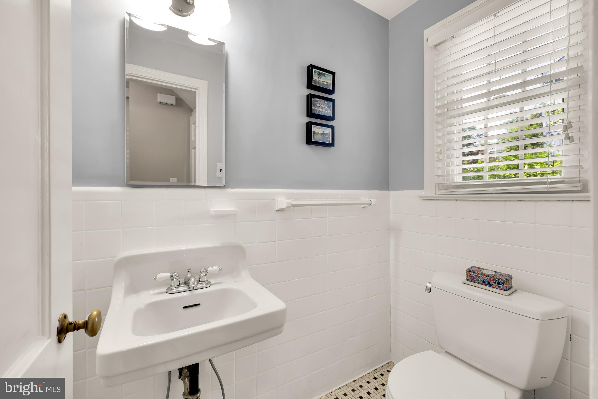 1802 August Drive Silver Spring, MD 20902 - Photo 11 of 26 a bathroom with a toilet sink and mirror