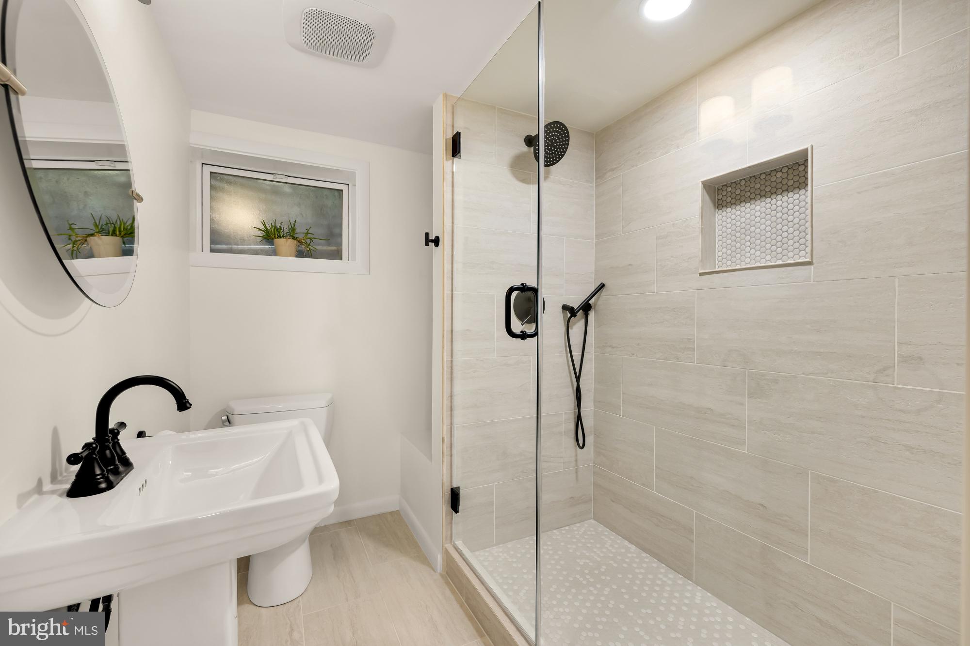 1802 August Drive Silver Spring, MD 20902 - Photo 19 of 26 a bathroom with a sink and mirror
