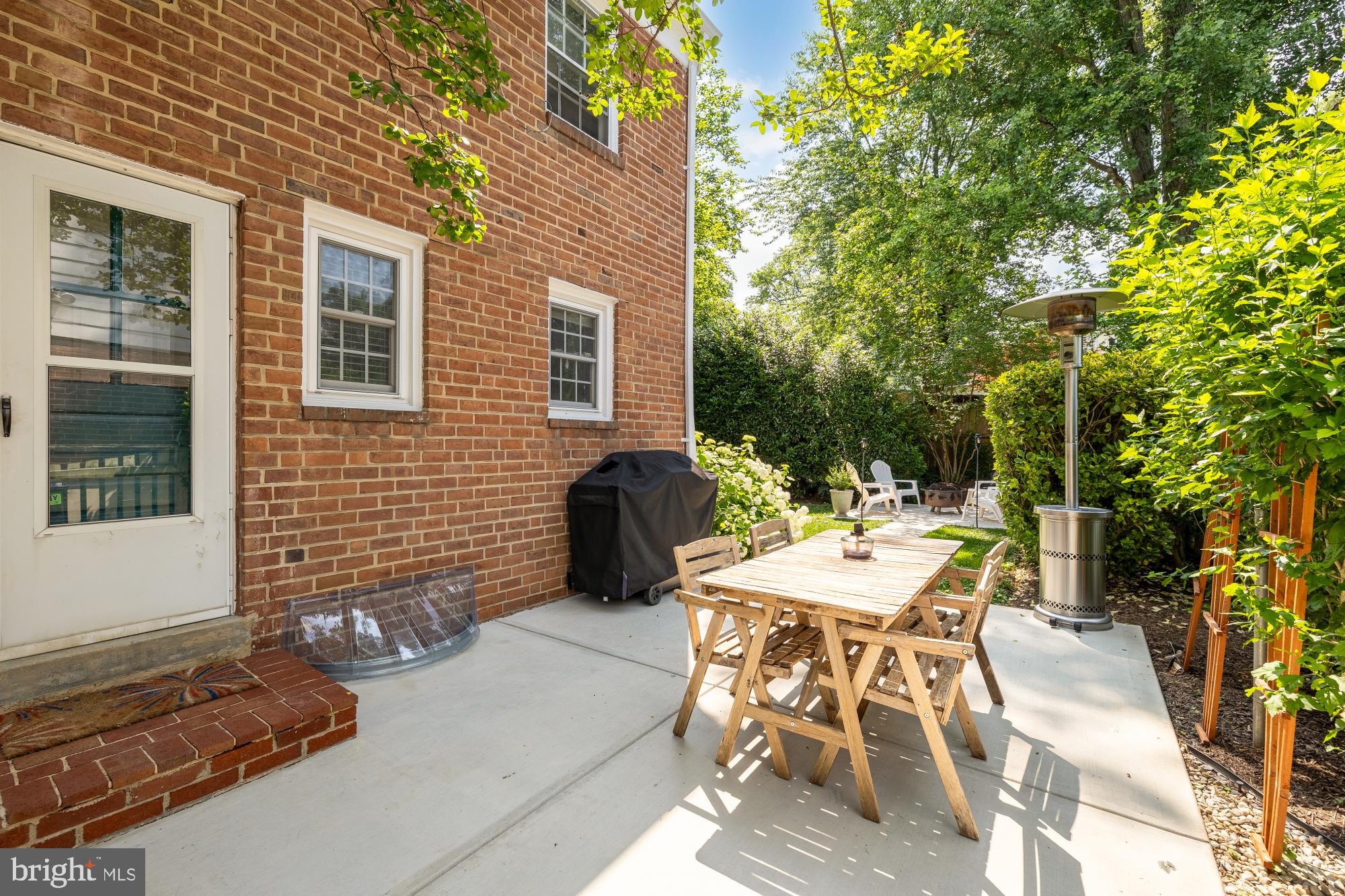 1802 August Drive Silver Spring, MD 20902 - Photo 23 of 26 a view of a patio with table and chairs and potted plants
