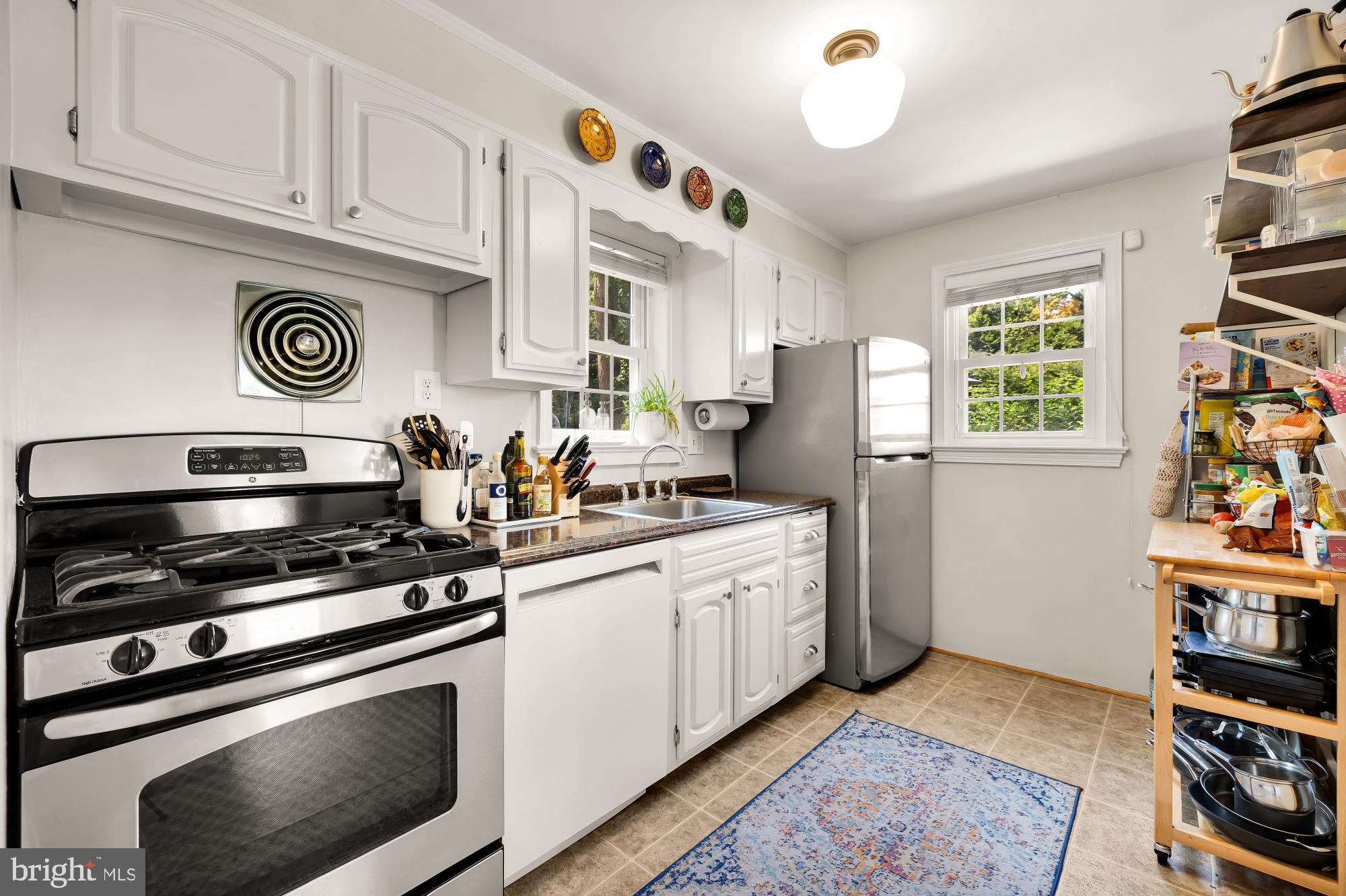 1802 August Drive Silver Spring, MD 20902 - Photo 10 of 26 a kitchen with stainless steel appliances a stove a refrigerator and a cabinets