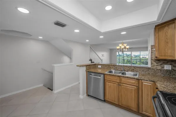 a kitchen with sink stove and cabinets
