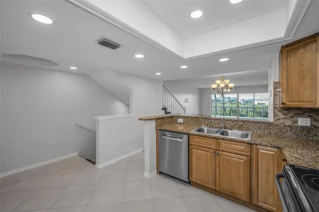 a kitchen with sink stove and cabinets