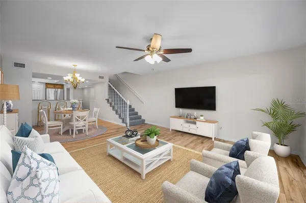 a living room with furniture a rug and a flat screen tv