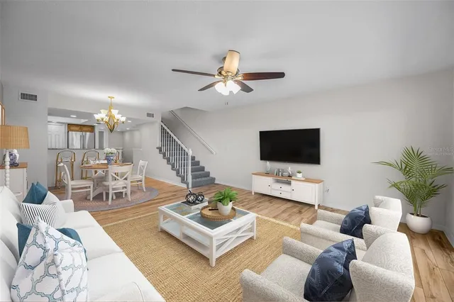 a living room with furniture a rug and a flat screen tv