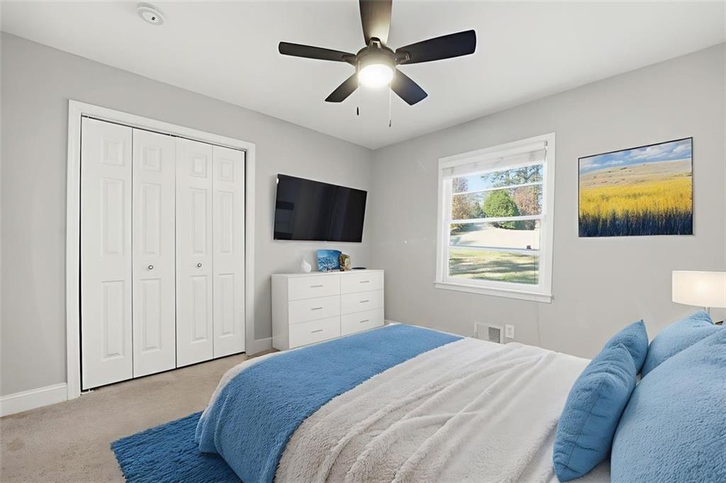 2002 Drew Valley Road Northeast Brookhaven, GA 30319 - Photo 14 of 51 a bedroom with a bed and a flat screen tv