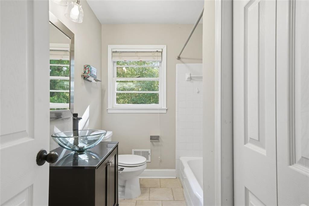 2002 Drew Valley Road Northeast Brookhaven, GA 30319 - Photo 15 of 51 a bathroom with a toilet a sink and a window