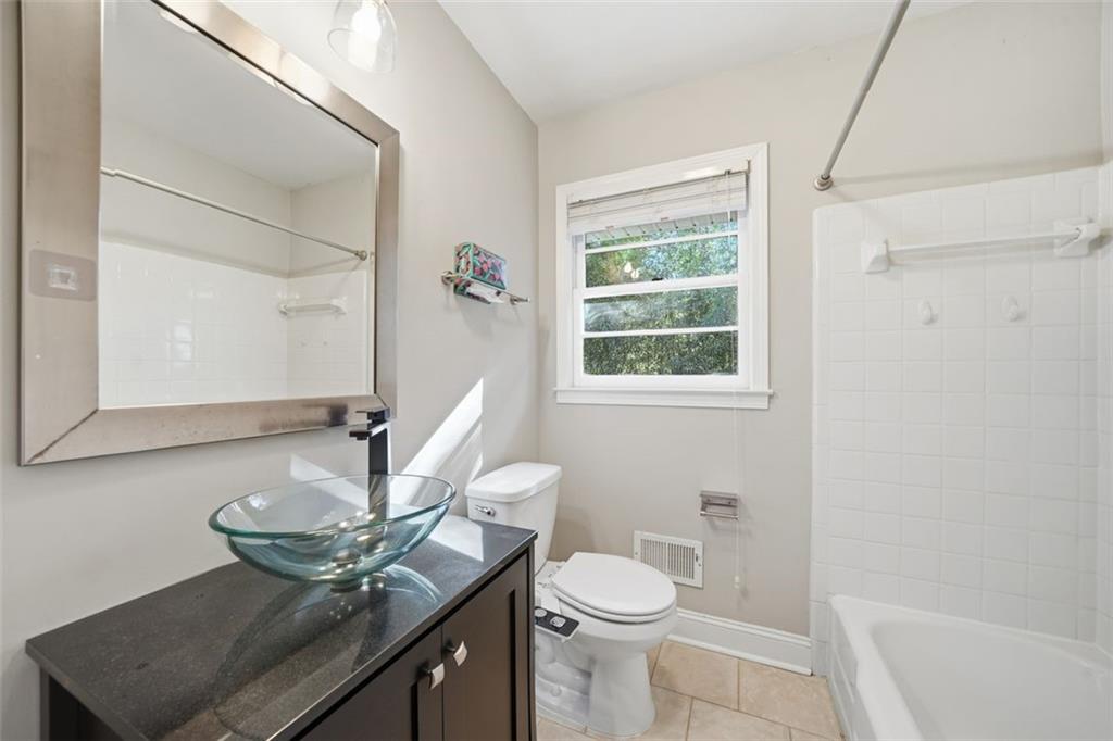 2002 Drew Valley Road Northeast Brookhaven, GA 30319 - Photo 16 of 51 a bathroom with a sink a toilet and a mirror