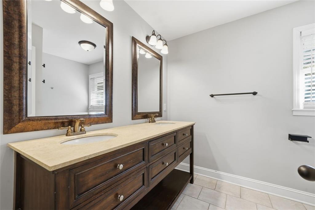 2002 Drew Valley Road Northeast Brookhaven, GA 30319 - Photo 21 of 51 a bathroom with a sink and a mirror