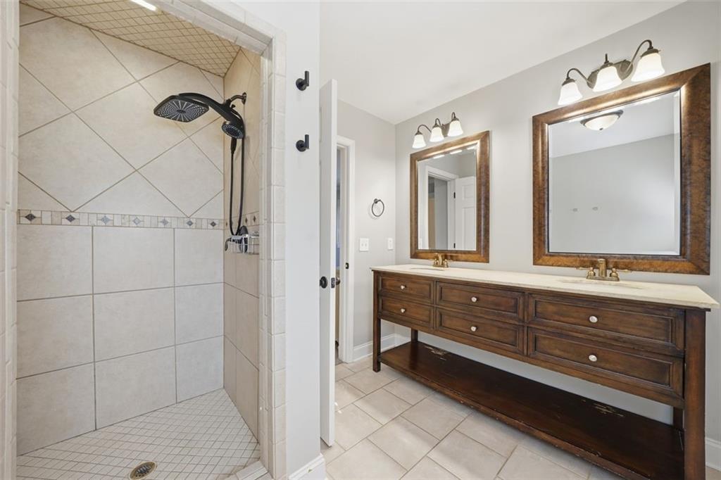 2002 Drew Valley Road Northeast Brookhaven, GA 30319 - Photo 22 of 51 a bathroom with a double vanity sink mirror and shower