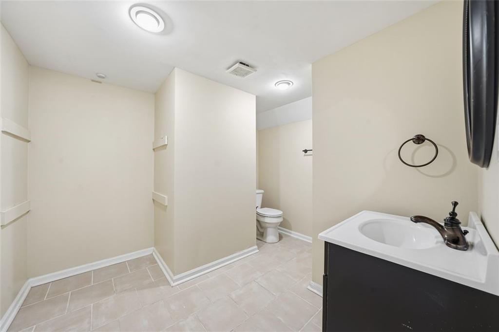 2002 Drew Valley Road Northeast Brookhaven, GA 30319 - Photo 35 of 51 a bathroom with a sink and a mirror