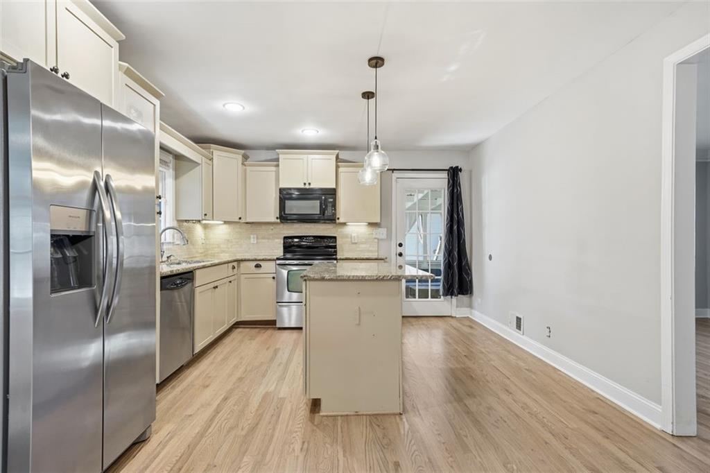 2002 Drew Valley Road Northeast Brookhaven, GA 30319 - Photo 9 of 51 a kitchen with a refrigerator a sink and cabinets