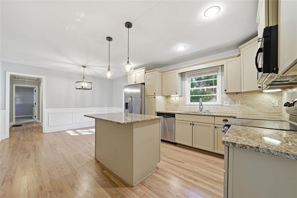 2002 Drew Valley Road Northeast Brookhaven, GA 30319 - Photo 10 of 51 a kitchen with stainless steel appliances granite countertop a sink a stove and a wooden floors