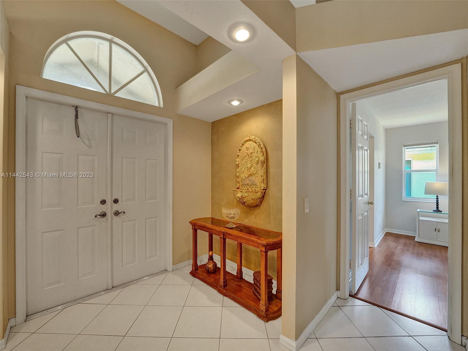 3273 Ridge Trace Davie, FL 33328 - Photo 16 of 74 a view of a hallway with entryway dining room and front door