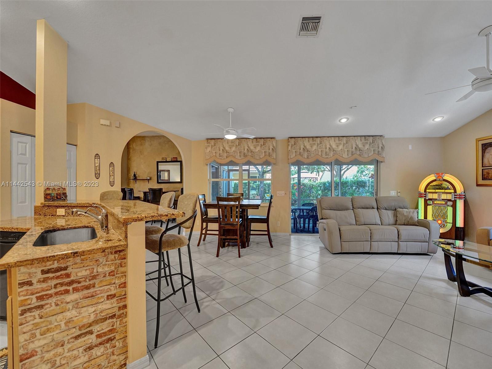 3273 Ridge Trace Davie, FL 33328 - Photo 26 of 74 a living room with furniture a floor to ceiling window and a flat screen tv