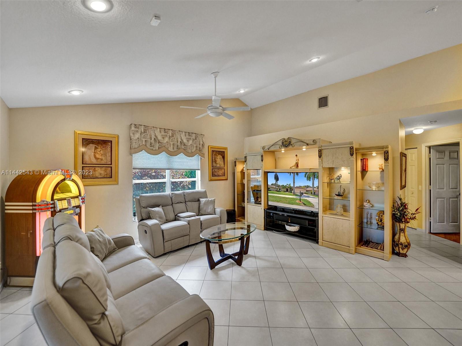3273 Ridge Trace Davie, FL 33328 - Photo 30 of 74 a living room with furniture a ceiling fan and a window