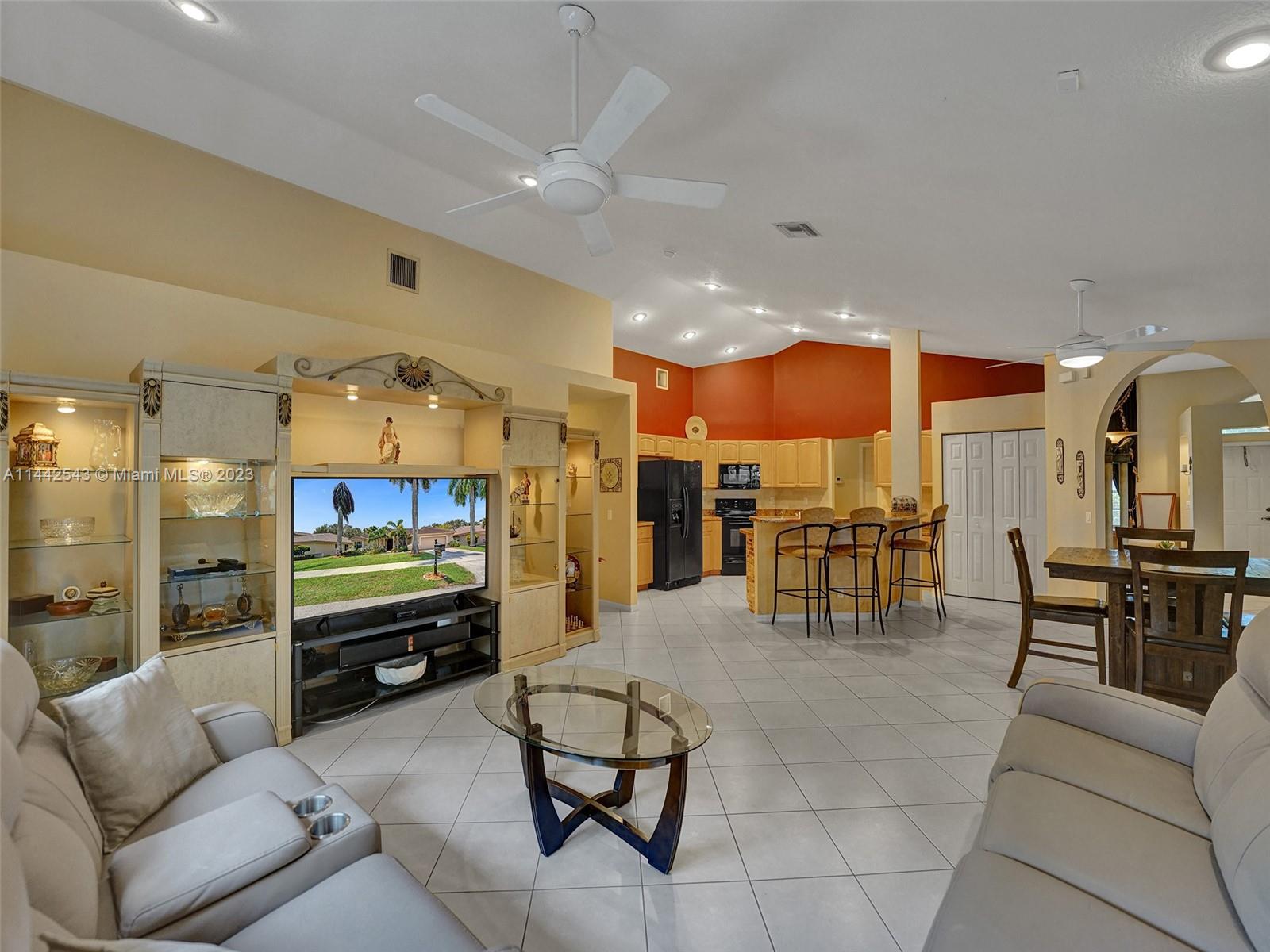 3273 Ridge Trace Davie, FL 33328 - Photo 32 of 74 a living room with furniture a kitchen view and a kitchen counter space