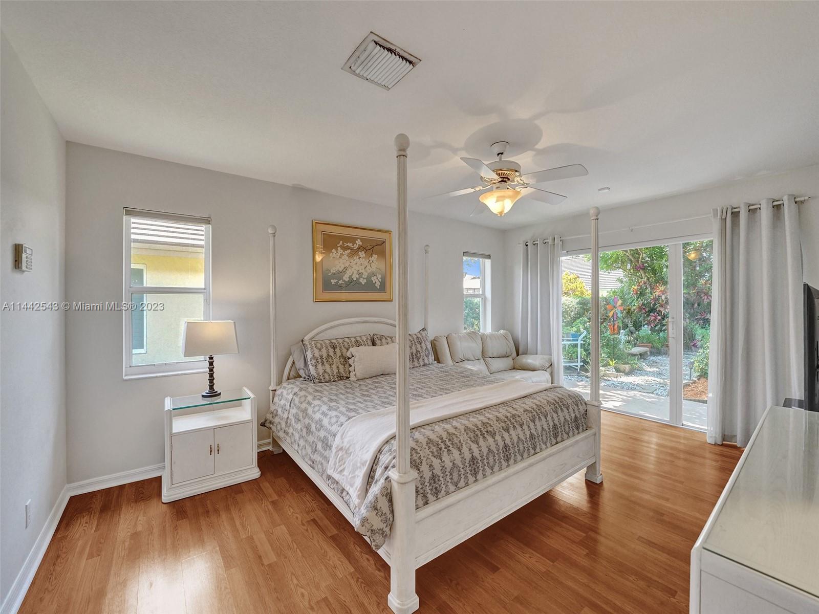 3273 Ridge Trace Davie, FL 33328 - Photo 34 of 74 a bedroom with a large bed and a chandelier