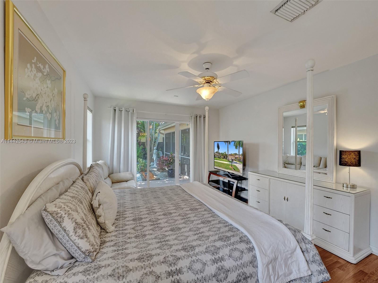 3273 Ridge Trace Davie, FL 33328 - Photo 36 of 74 a bedroom with a large bed and a tv