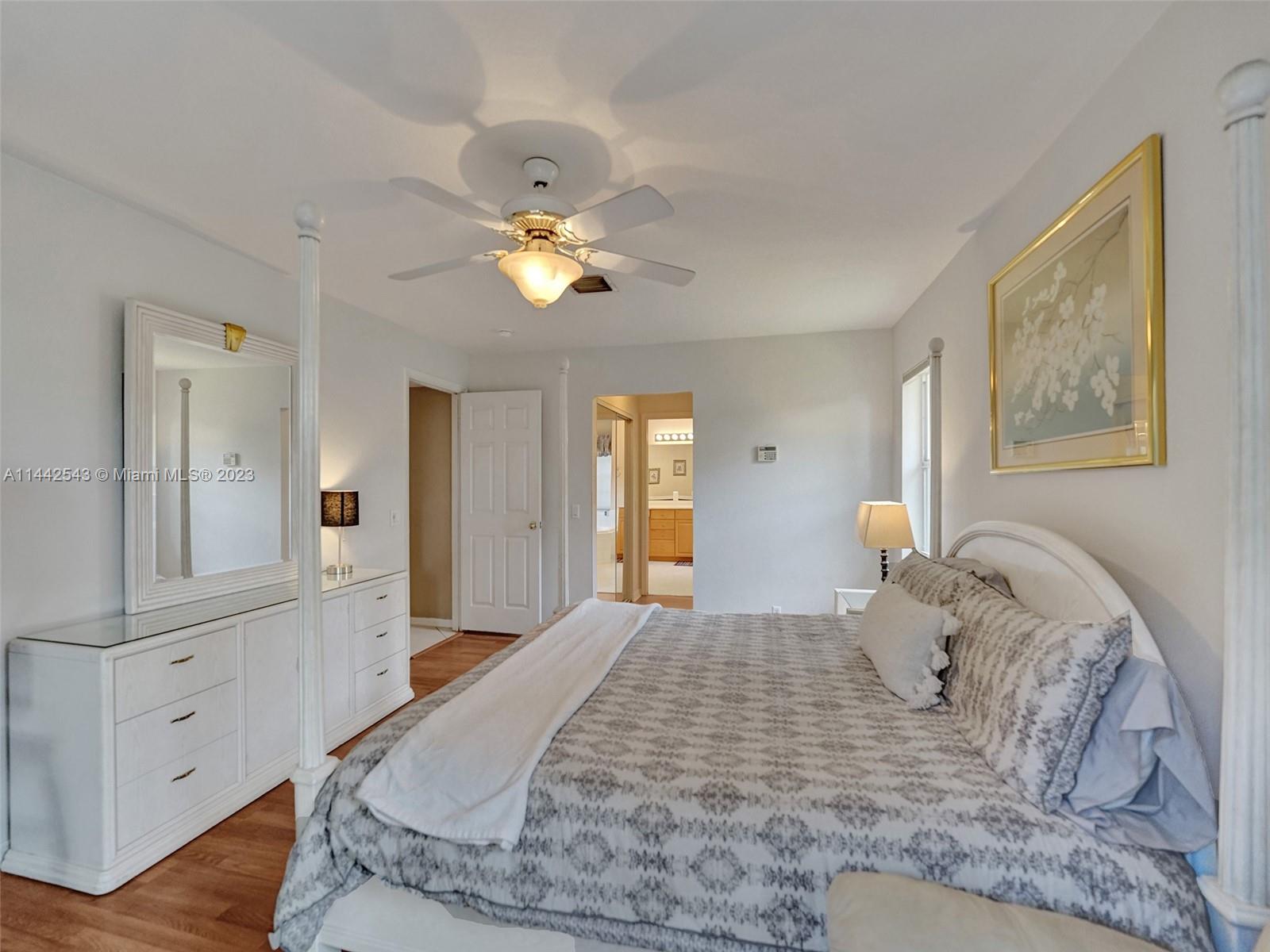 3273 Ridge Trace Davie, FL 33328 - Photo 38 of 74 a bedroom with a bed and a chandelier