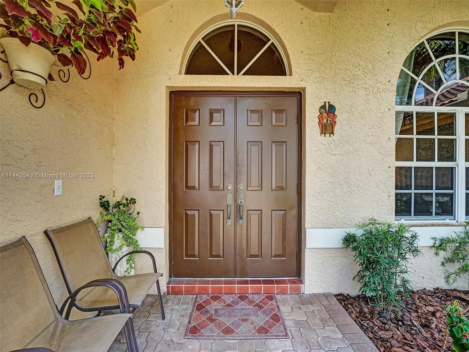 3273 Ridge Trace Davie, FL 33328 - Photo 4 of 74 a view of a porch with a table and chairs