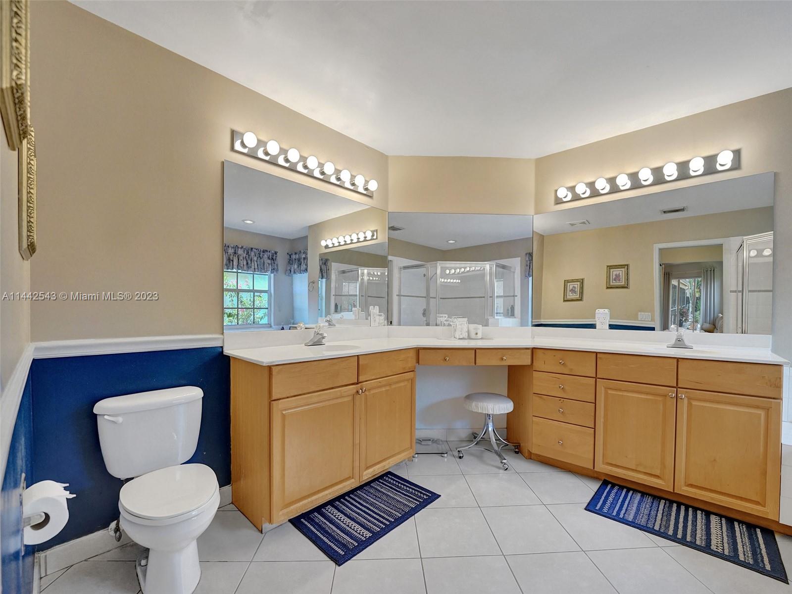 3273 Ridge Trace Davie, FL 33328 - Photo 41 of 74 a bathroom with a toilet sink and mirror