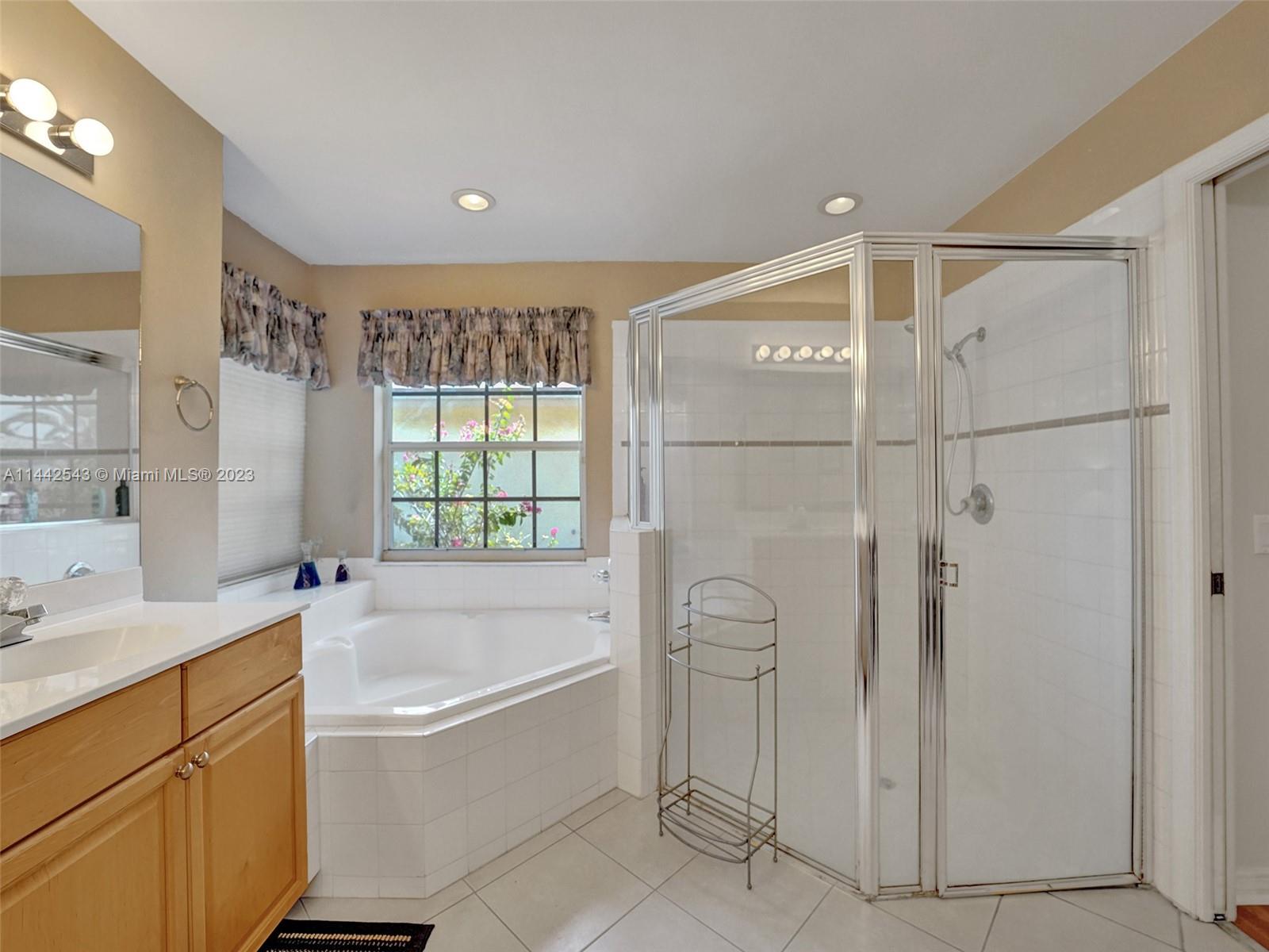 3273 Ridge Trace Davie, FL 33328 - Photo 42 of 74 a bathroom with a bathtub and a shower