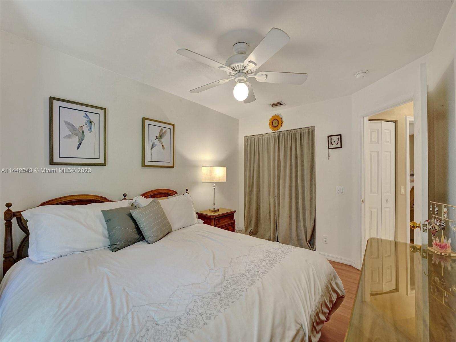 3273 Ridge Trace Davie, FL 33328 - Photo 45 of 74 a bedroom with a bed and a chandelier