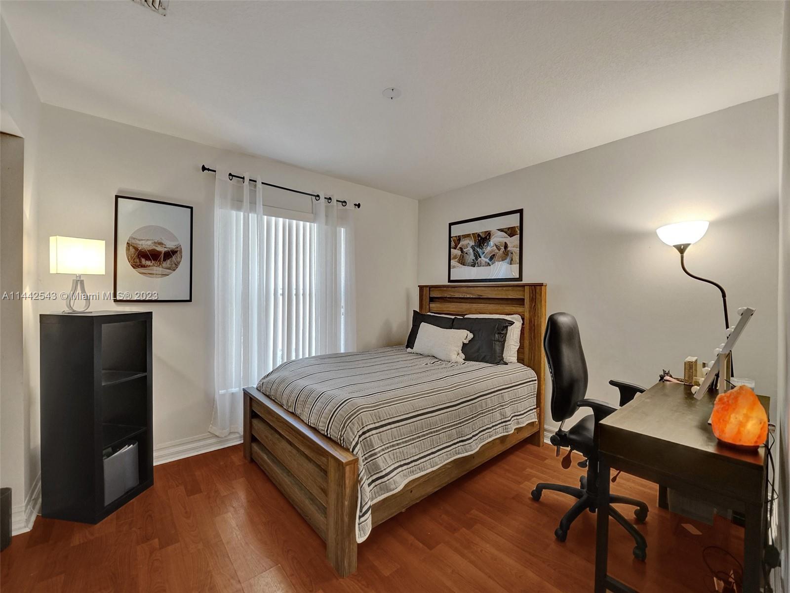 3273 Ridge Trace Davie, FL 33328 - Photo 49 of 74 a bedroom with a bed and a table in it