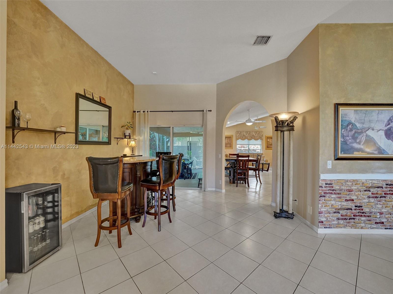 3273 Ridge Trace Davie, FL 33328 - Photo 5 of 74 a dining hall with stainless steel appliances a dining table and chairs with the view of kitchen