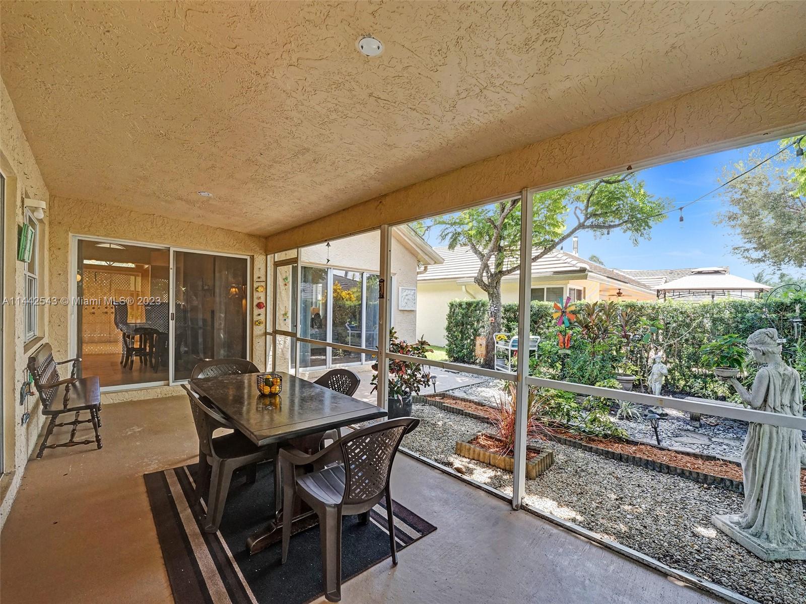 3273 Ridge Trace Davie, FL 33328 - Photo 60 of 74 a view of a patio with table and chairs and floor to ceiling window