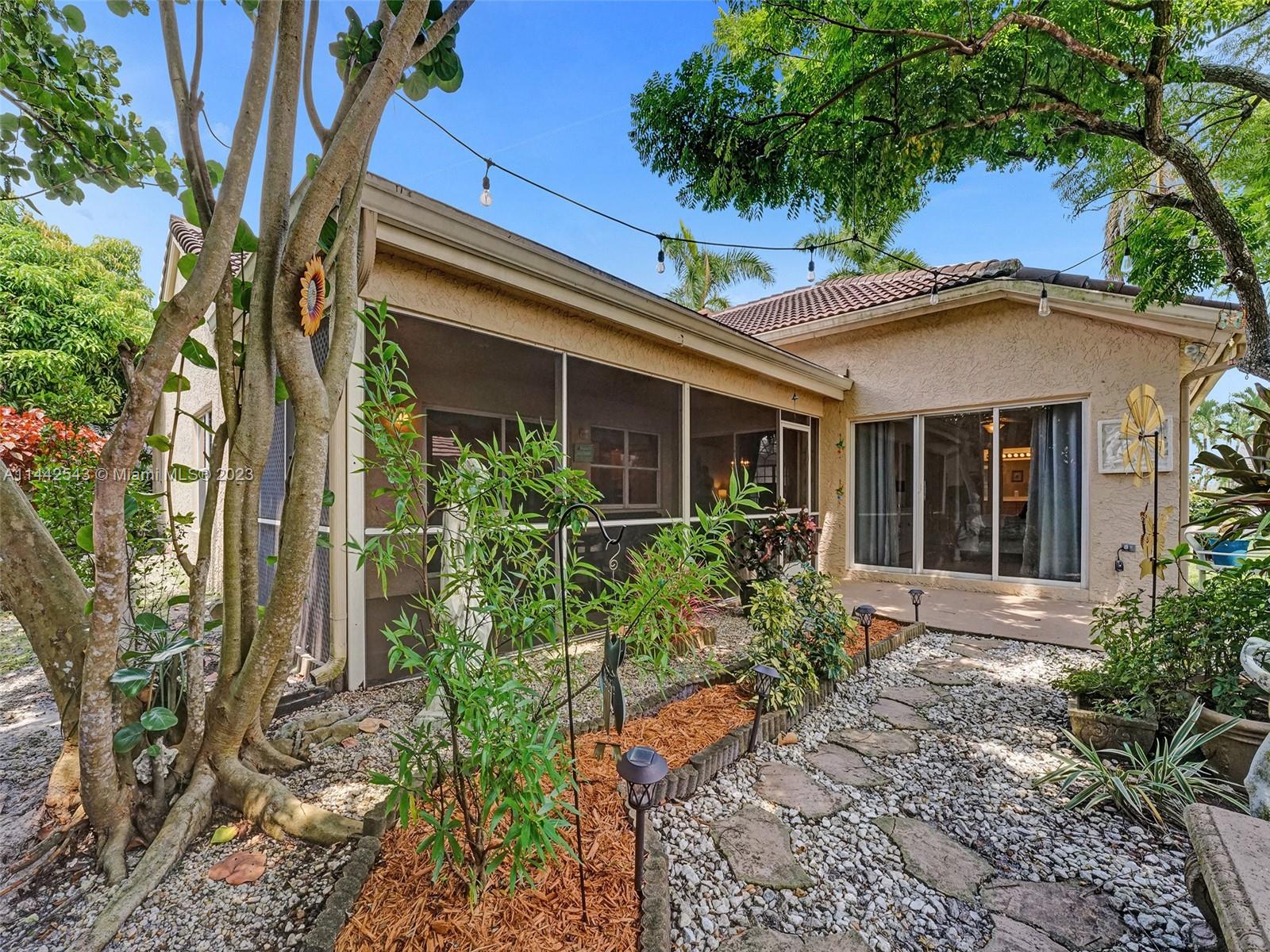3273 Ridge Trace Davie, FL 33328 - Photo 67 of 74 a front view of a house with garden