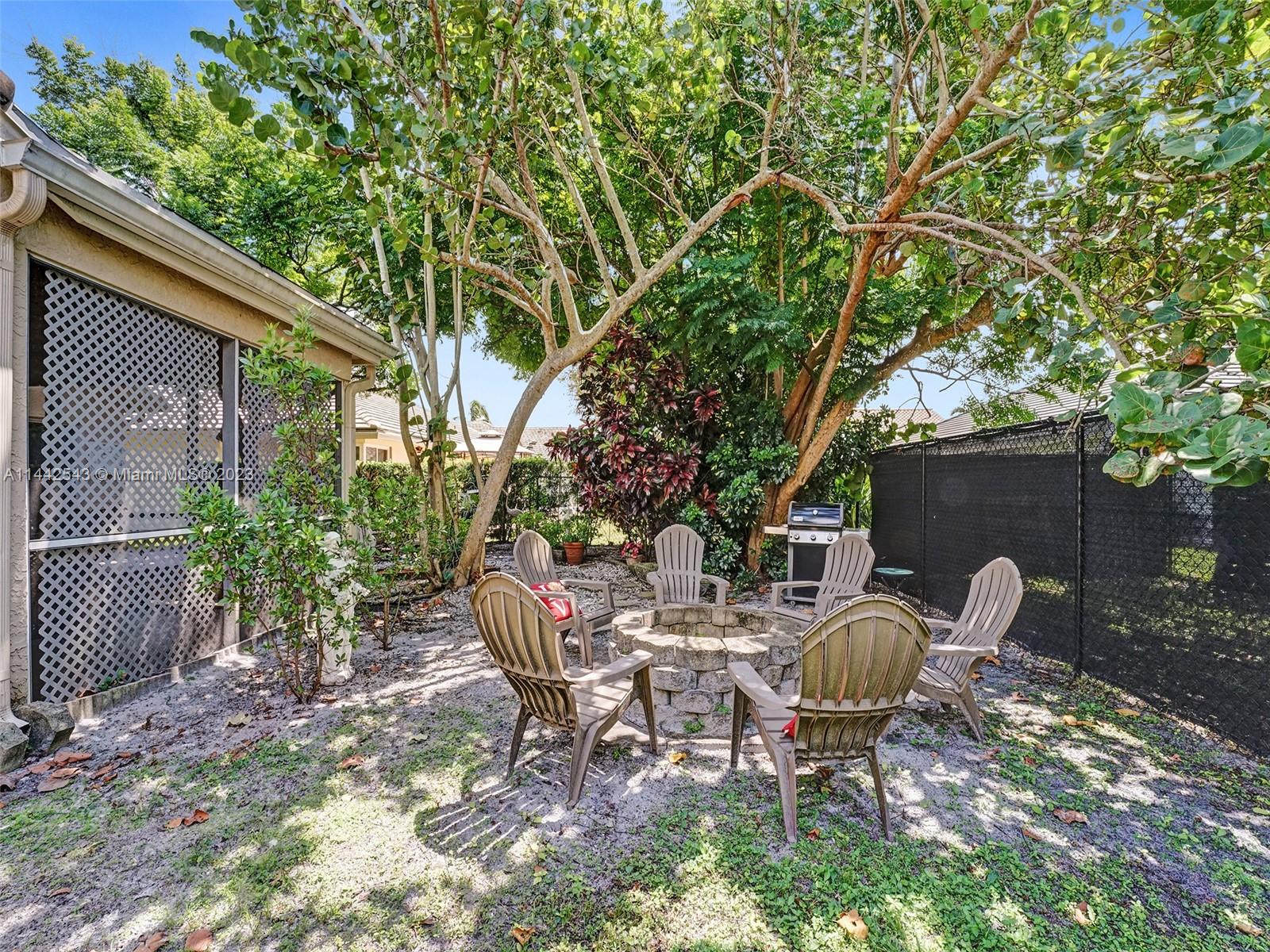 3273 Ridge Trace Davie, FL 33328 - Photo 70 of 74 a view of a chairs and table in backyard