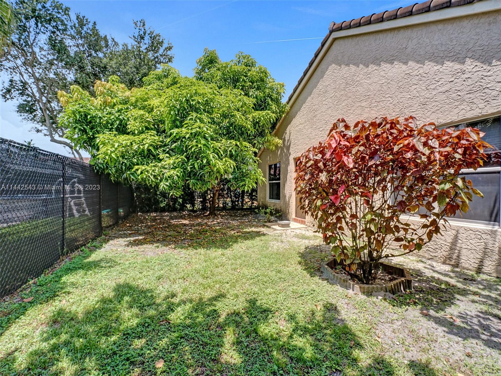 3273 Ridge Trace Davie, FL 33328 - Photo 72 of 74 a backyard of a house with lots of green space