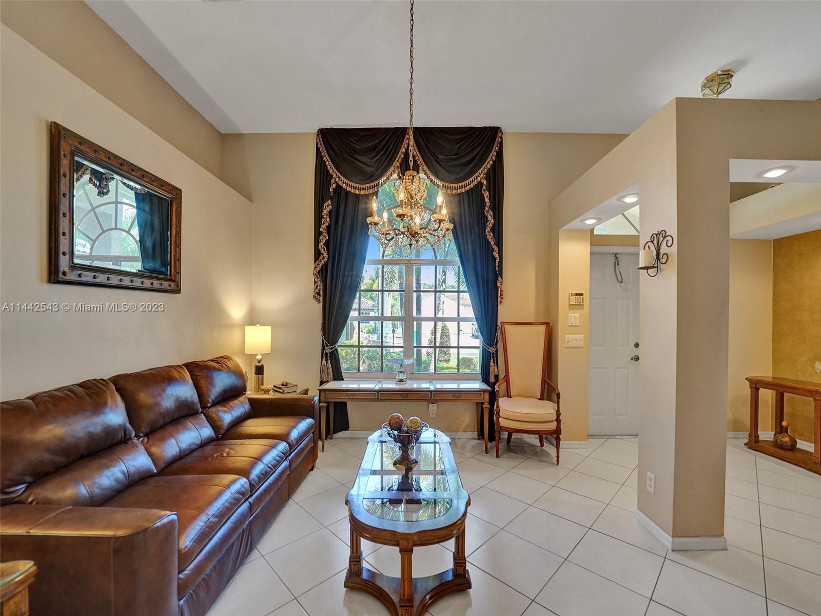 3273 Ridge Trace Davie, FL 33328 - Photo 9 of 74 a living room with furniture chandelier and window