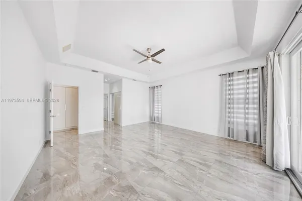 an empty room with closet and windows