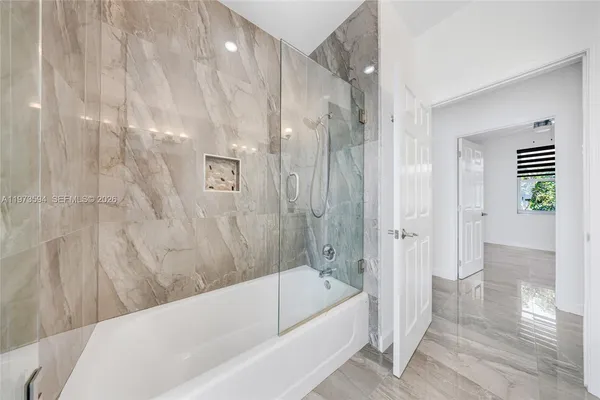 a bathroom with a bathtub and a shower