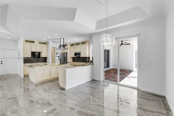 a large white kitchen with cabinets and stainless steel appliances