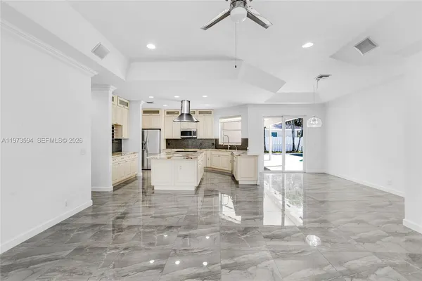 a large kitchen with cabinets and stainless steel appliances