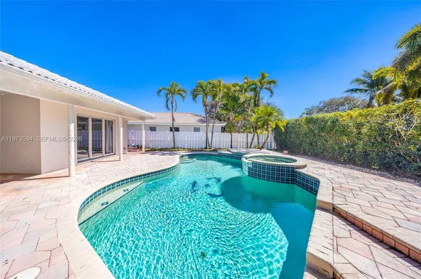 a view of house with swimming pool outdoor seating