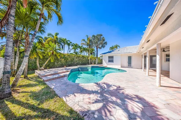 a view of a house with wooden fence and floor to ceiling window