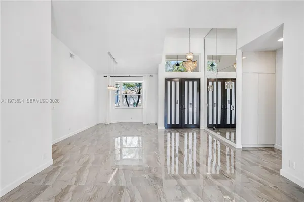 a view of wooden floor and windows in a room