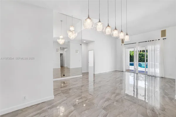 a view of a big room with chandelier fan and windows