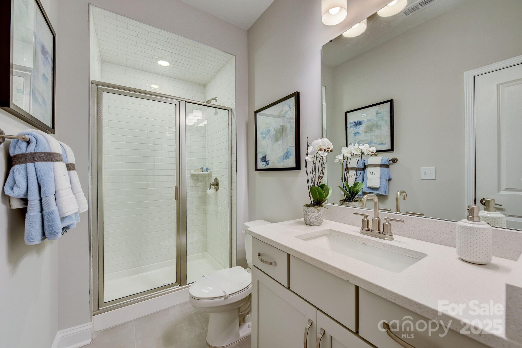 411 Jetton Street Davidson, NC 28036 - Photo 13 of 37 a bathroom with a sink toilet and shower