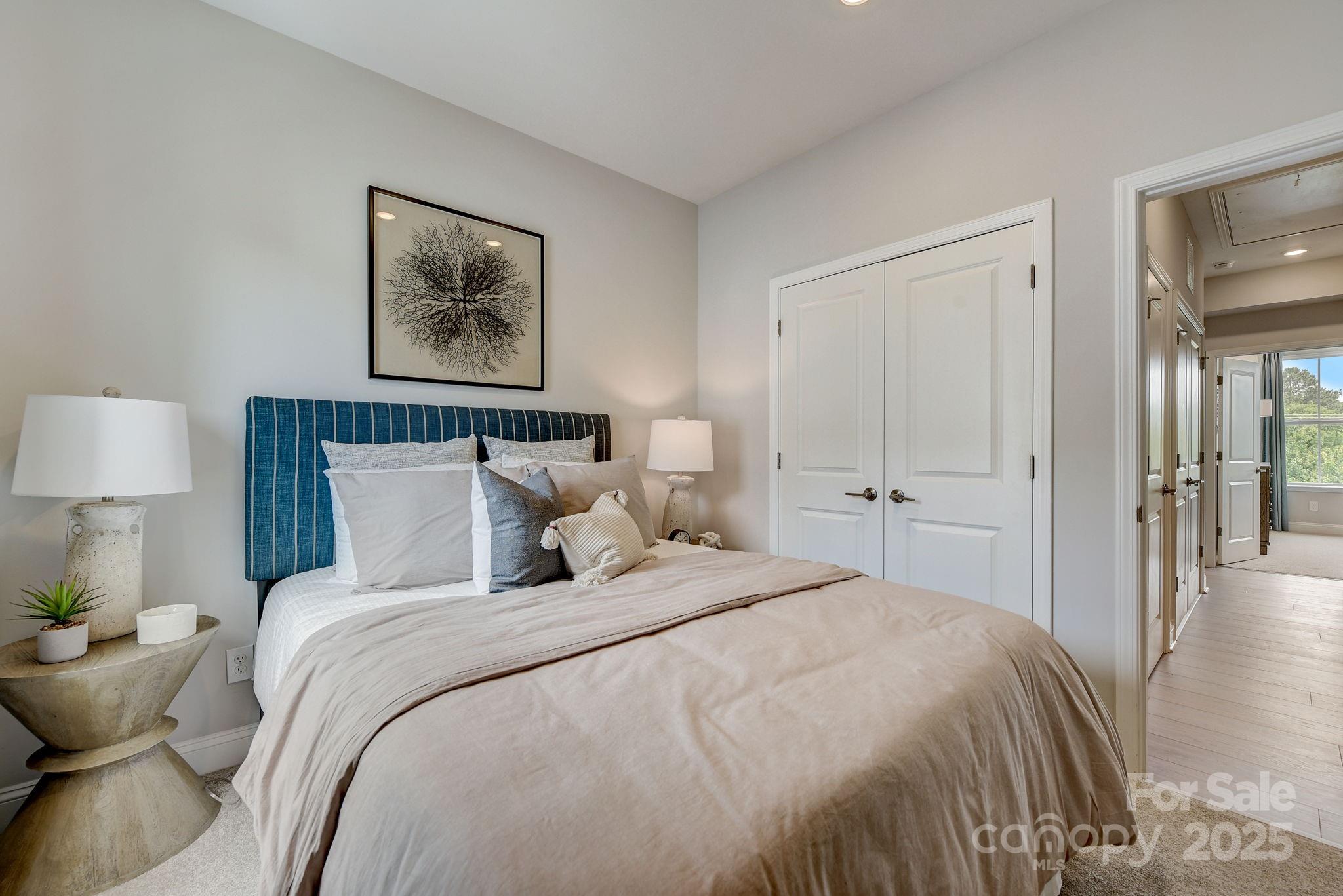 411 Jetton Street Davidson, NC 28036 - Photo 25 of 37 a bedroom with bed and painting on the wall