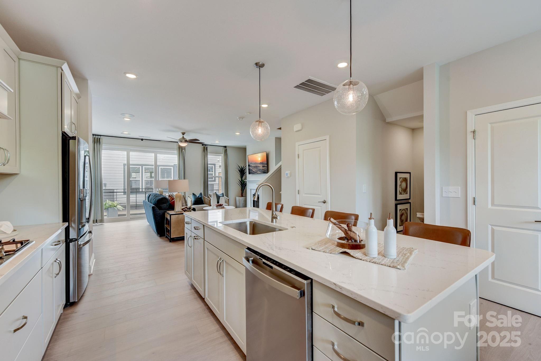 411 Jetton Street Davidson, NC 28036 - Photo 4 of 37 a kitchen with a sink appliances and a counter top space