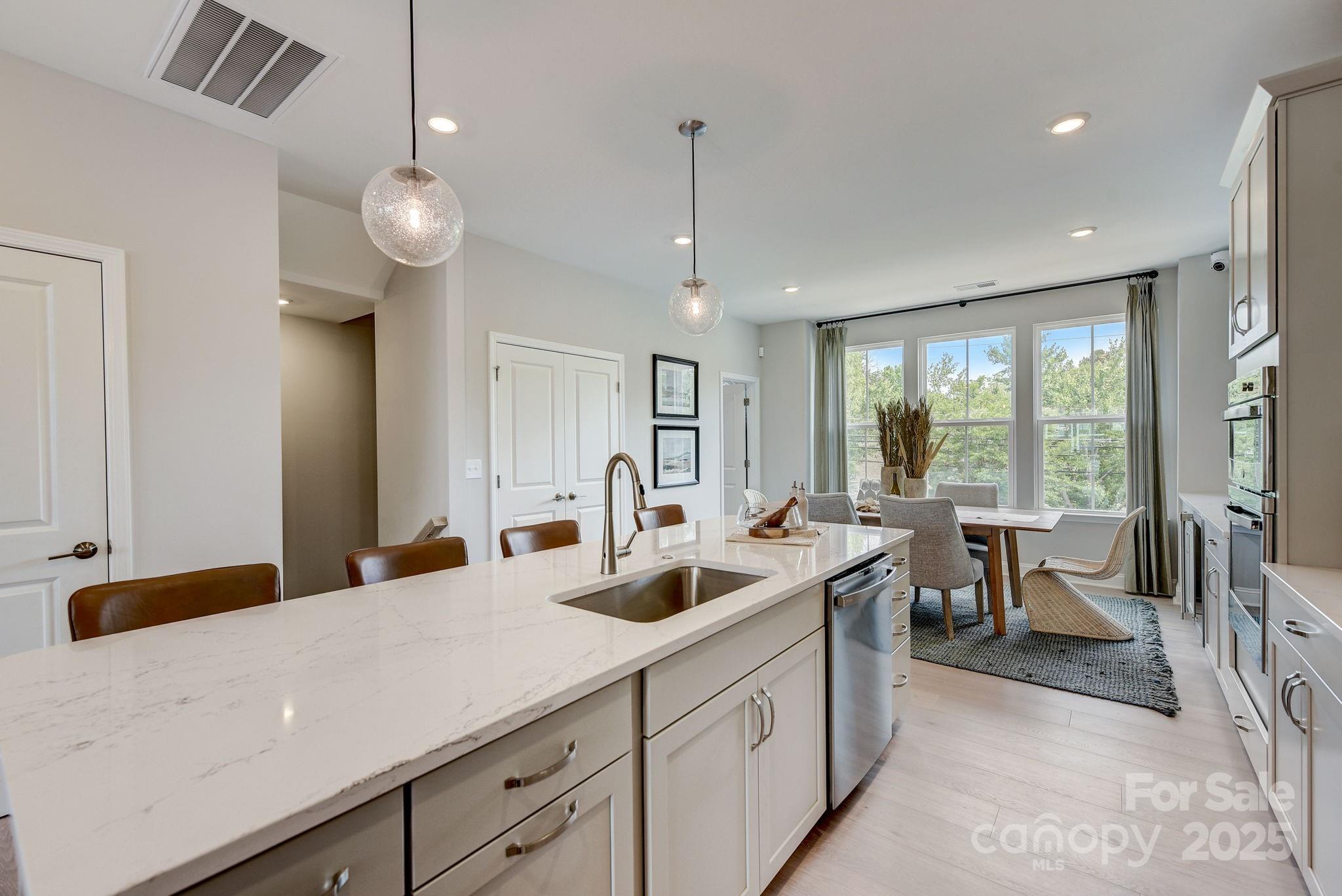 411 Jetton Street Davidson, NC 28036 - Photo 5 of 37 a kitchen with sink and view of living room