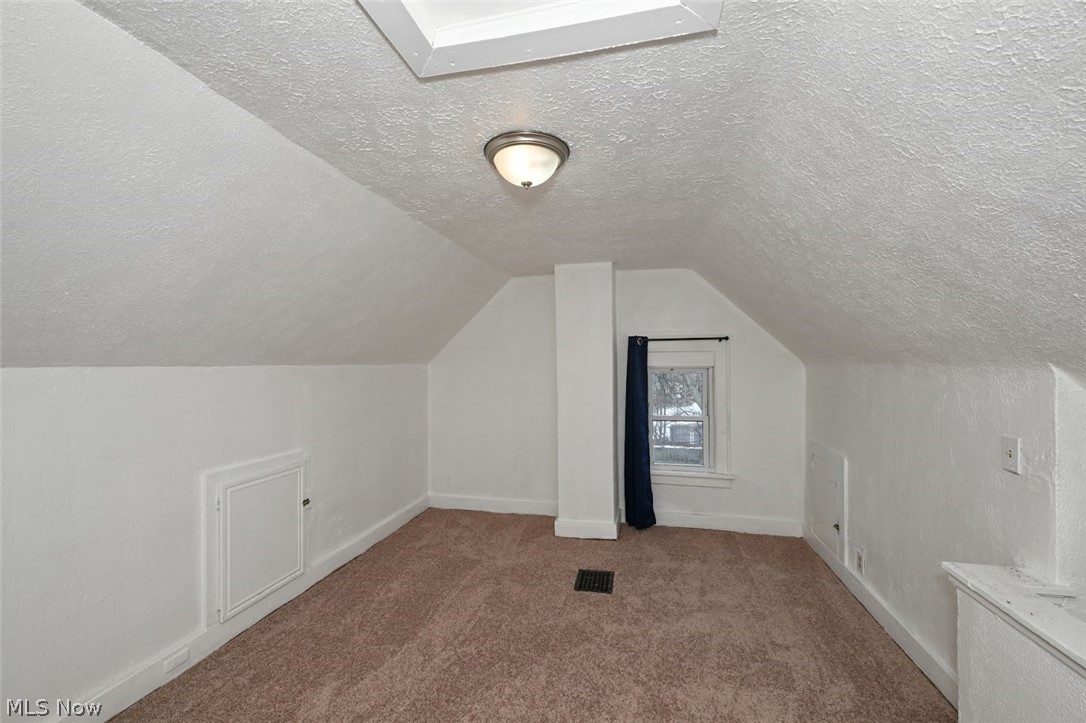 77 West Mildred Avenue Akron, OH 44310 - Photo 35 of 40 Bonus room featuring carpet floors and a textured ceiling