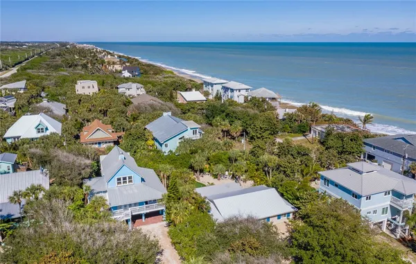 an aerial view of residential houses with outdoor space