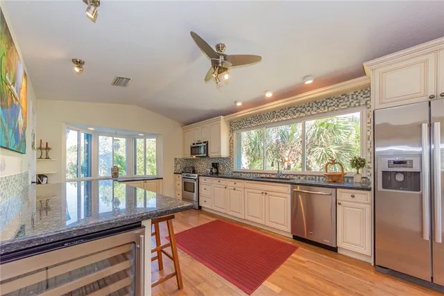 a kitchen with stainless steel appliances granite countertop a stove and refrigerator