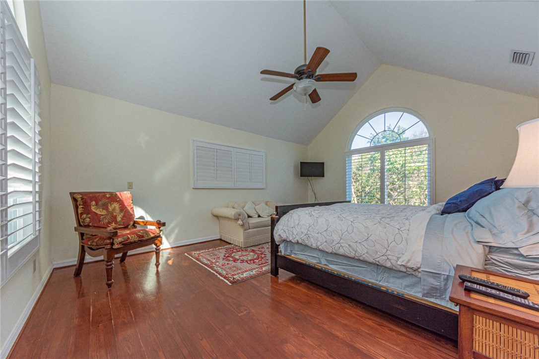 1850 East Sandpiper Road Vero Beach, FL 32963 - Photo 16 of 36 a bedroom with a bed and wooden floor